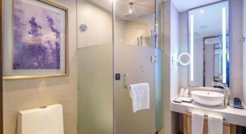 a bathroom with a sink and a toilet and a shower at Lavande Hotels·Yichang Wanda Plaza in Yichang