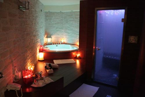 a bathroom with a bath tub with lights on it at Cristal Palace Hotel in Madonna di Campiglio