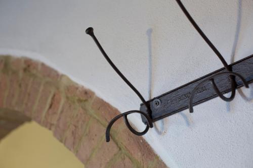 a pair of glasses hanging from a wall at Casa vacanza vicolo degli orti in Monticiano