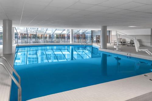 a large pool with blue water in a building at DoubleTree by Hilton Hotel South Bend in South Bend