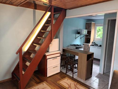 a loft bed with a desk and a staircase in a kitchen at Casa Villagio - CONDOMÍNIO in Gramado