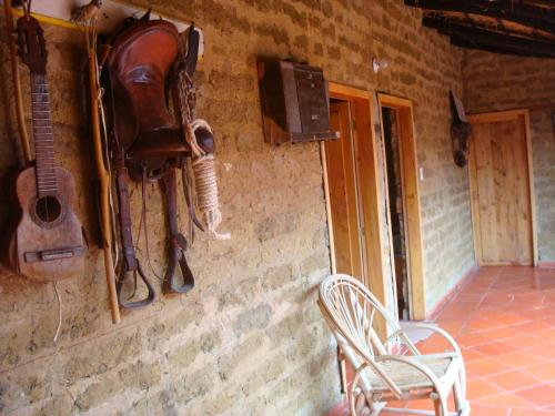 a horse hanging on a wall next to a chair at Monzaque- paraíso de bachué in El Barrial
