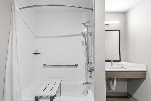 a bathroom with a shower and a sink at Echo Suites Extended Stay by Wyndham Atlanta-Conyers in Conyers