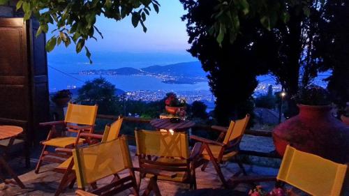 a group of chairs and a table with a view at Archontiko Pantou in Portariá