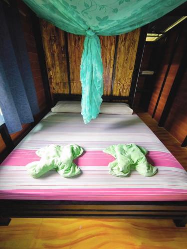 two baby elephants laying on a bed at Tadangbay bungalow in Koh Chang Ranong