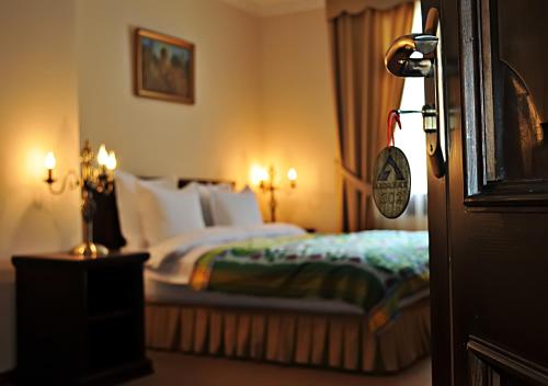 a hotel room with a bed with white pillows at L'Argamak in Samarkand