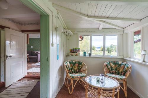 a room with a table and chairs and a window at Horsvik - Hagstugan in Studsvik