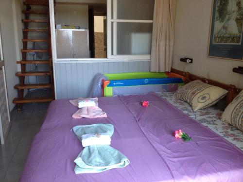 a bed in a room with two dolls on it at Alkyonis Apartments in Panormos Kalymnos