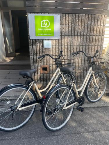 two bikes parked in front of a building at 栗林公園のほとり-Garden Nook- in Takamatsu