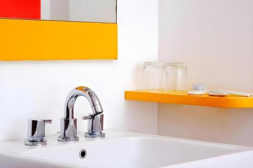 a kitchen sink with a counter top with a sink at Amaris Hotel Pakuan Bogor in Bogor