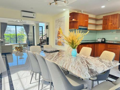 a kitchen and dining room with a table and chairs at Cacua villa 6 bedrooms in Phu Quoc