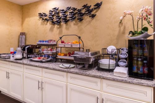 a kitchen with a counter with food on it at Inn of The Dove Romantic Luxury & Business Suites in Bensalem
