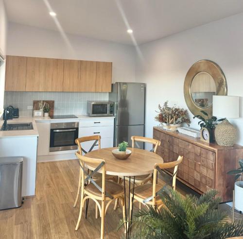 a kitchen with a table and chairs in a kitchen at 2BR Charlestown Guesthouse Coastal Views Breakfast in Charlestown
