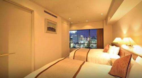 Postel nebo postele na pokoji v ubytování Hotel Harvest In Yonago