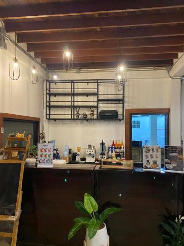 a kitchen with a counter in a room at Uncle Matts Cafe and Chill in Ban Yang Pa Kha