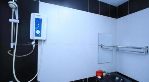 a bathroom with a shower and a sink in a room at OYO 115 Hotel Safari 1 in Kuala Lumpur