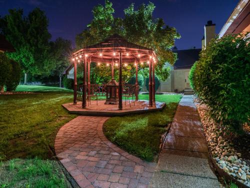 a gazebo with lights in a yard at night at Inn of The Dove Romantic Luxury & Business Suites in Bensalem