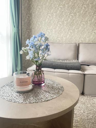 a coffee table with a vase of blue flowers on it at 栗林公園のほとり-Garden Nook- in Takamatsu