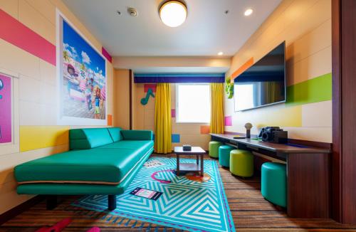 a living room with a green couch and a table at LEGOLAND Japan Hotel in Nagoya
