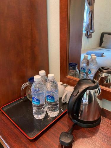 a tray with two bottles of water on a table at Highlanders Garden Guesthouse at Arundina Cameron Highlands in Cameron Highlands