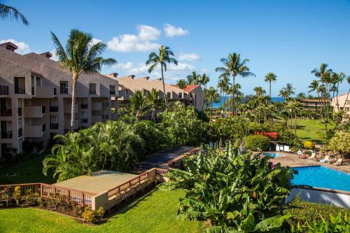 an aerial view of a resort with a pool and palm trees at Castle Kama'ole Sands in Wailea