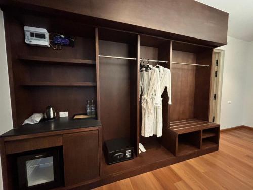 a room with a closet with a shirt hanging on it at Sann Boutique Nan in Nan