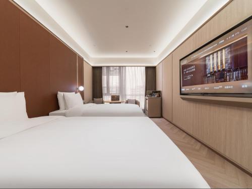 Ένα ή περισσότερα κρεβάτια σε δωμάτιο στο Orange Crystal Hotel Shanghai Hongqiao Airport International Exhibition Center