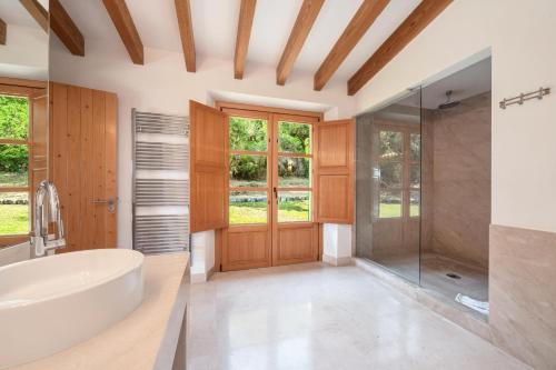 a bathroom with a large tub and a shower at Can Perot - Pollença in Pollença