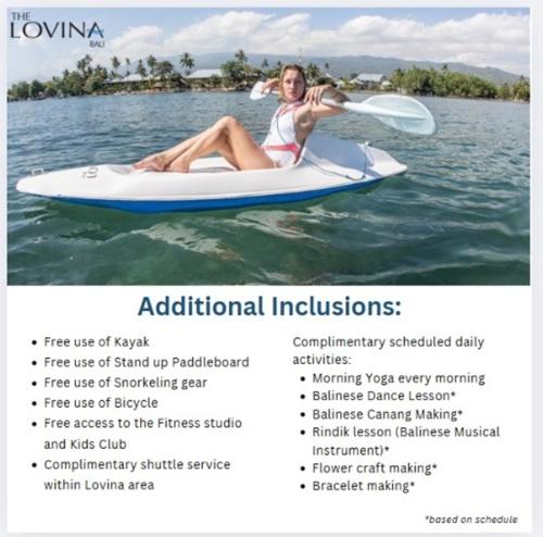 a woman is sitting on a paddle board on the water at The Lovina in Lovina