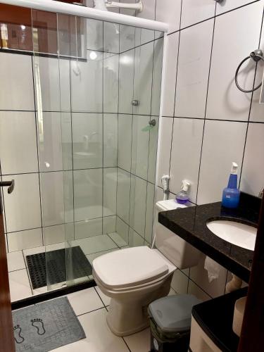 a bathroom with a shower and a toilet and a sink at Suíte férias in Cabo Frio