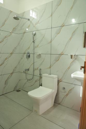 a bathroom with a toilet and a sink at Rain Drops Homestay in Anachal