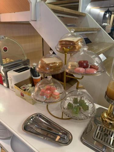 a kitchen counter with four plates of food on it at Dequan Luxury Hotel National Exhibition Center Wangjing Bridge Branch The subway is right outside the door Coffee, snacks, a gym and a laundry room are provided for free in the lobby in Beijing