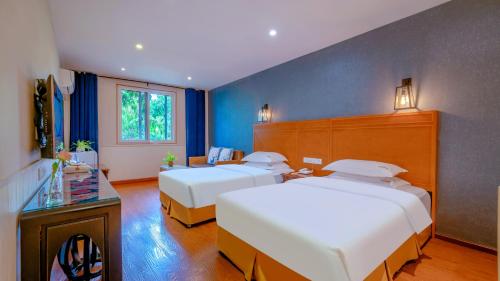 Una cama o camas en una habitación de Wenjun Courtyard Hotel ---5 mins walk from Tonghuimen metro station, near Tianfu square, close by culture park and Sichuan opera house, English speaking service, local tours