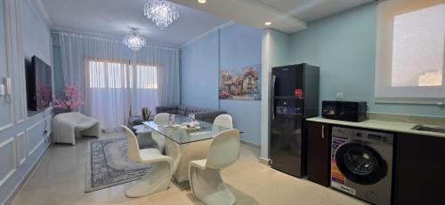 a living room with a table and chairs at Peaceful Apartments in Dubai
