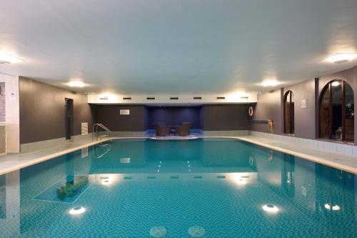 a large swimming pool in a hotel room at Landal Whitbarrow in Penruddock