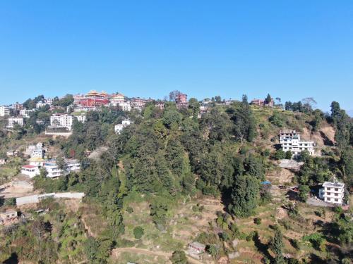 a hill with houses on top of a mountain at Hotel Swornim Namobuddha in Dhulikhel