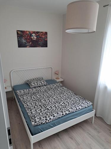 a small bedroom with a white bed and a lamp at CZARTORYSKICH 7 - 3 pokoje - Faktura - Parking w cenie !! in Puławy