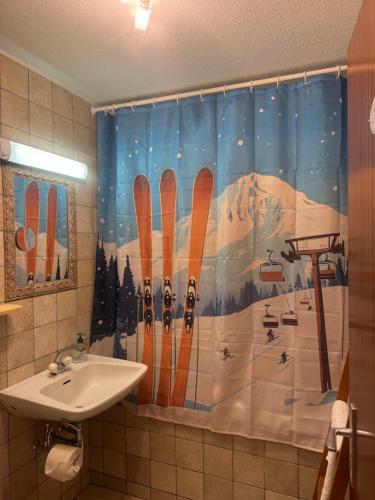 Un baño con una cortina de ducha con esquís. en Sunny Swiss mountain Studio in centre by Jolidi, en Nendaz