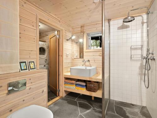 a bathroom with a sink and a shower at Family Cabin With Hot Tub In Hønedalen in Haugen