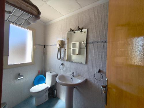 a bathroom with a sink and a toilet and a mirror at Apartamentos Bellavista in Puerto de Mazarrón