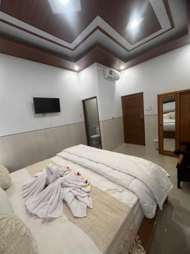 Ένα ή περισσότερα κρεβάτια σε δωμάτιο στο Umah Aget