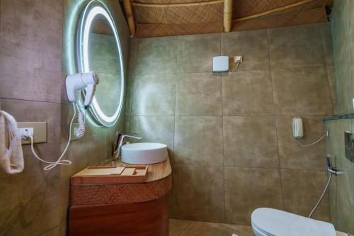 a bathroom with a sink and a mirror at ONENESS Rishikesh by Ganga Kinare - A Luxury Wilderness Resort in Rishīkesh