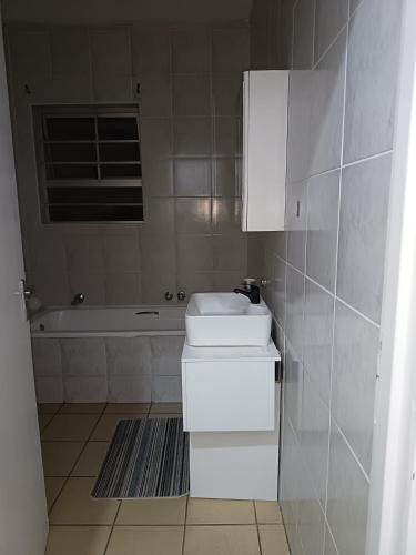 a bathroom with a toilet and a sink and a tub at Queens Gardens in Margate