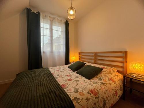 a bedroom with a bed with two pillows on it at L'Escale Champenoise - independent accommodation in Hautvillers