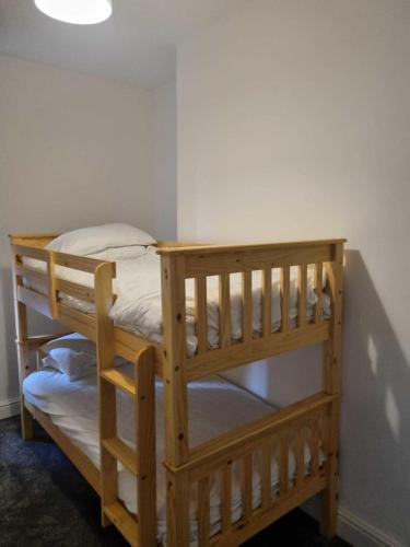 a couple of bunk beds in a room at St Hilary Central Apartment in Llandudno