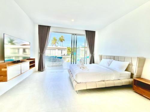 a bedroom with a large bed and a television at Jungle View 3 bedroom Pool Villa in Meanam in Koh Samui 