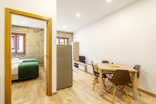 a room with a table and a bed and a mirror at Two 2 Two Urban Stay in Vila Real