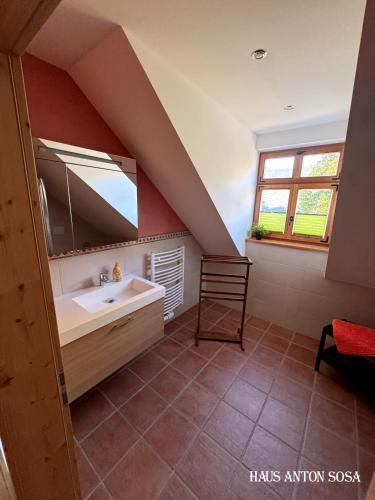 a bathroom with a sink and a mirror at Ferienhaus Anton in Eibenstock