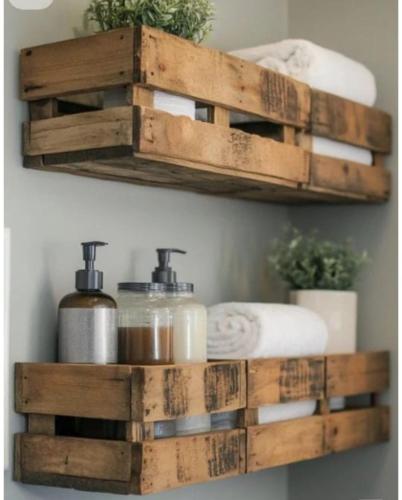 a bathroom with two wooden shelves with towels at Little Loti Sikumana in Maulafa