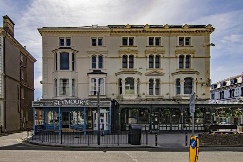 a large building with a store in front of it at Montague House Apartments in Llandudno